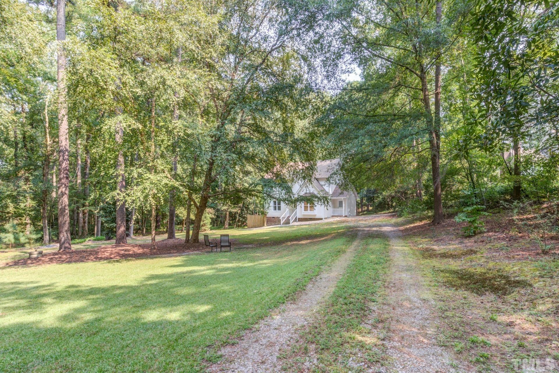 3240 Cornwallis Road Garner, NC 27529 - Photo 3 of 30 The home is set far back on the 1.34 acre property at the curve of the convenient horseshoe driveway.
