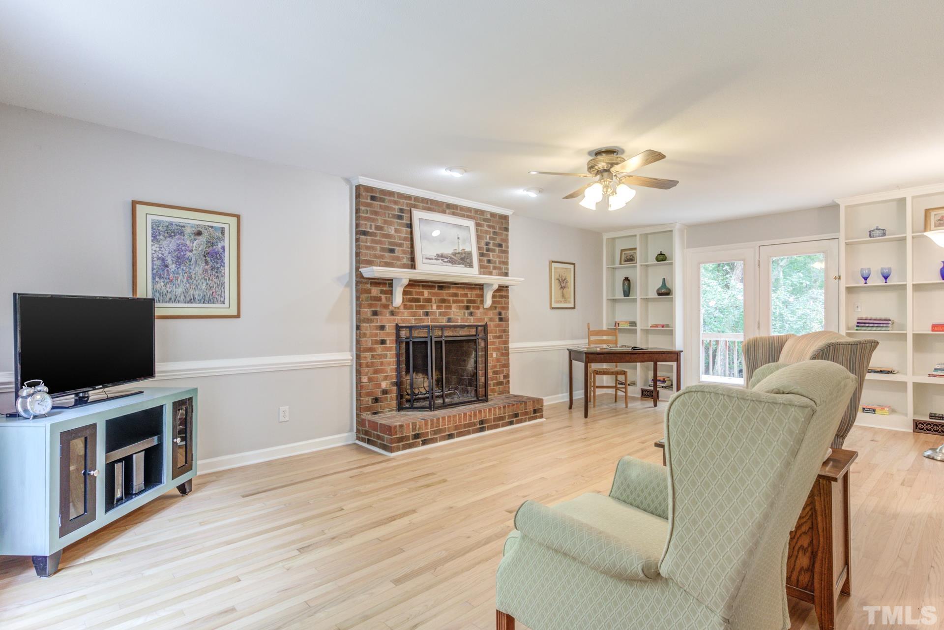 3240 Cornwallis Road Garner, NC 27529 - Photo 7 of 30 Stunning hardwoods, built-in shelving, and a gorgeous masonry fireplace!