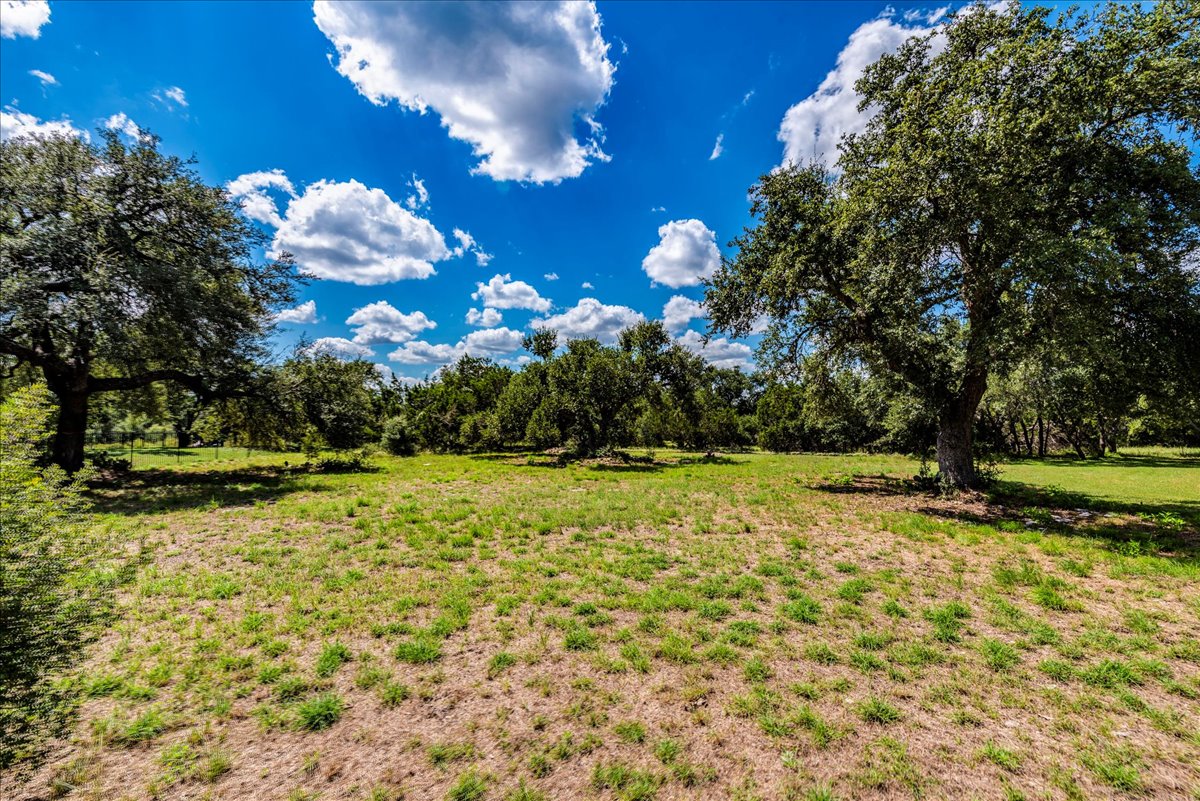 10299 Brangus Road Driftwood, TX 78619 - Photo 6 of 16 View of grassy yard featuring a view of rural / pastoral area