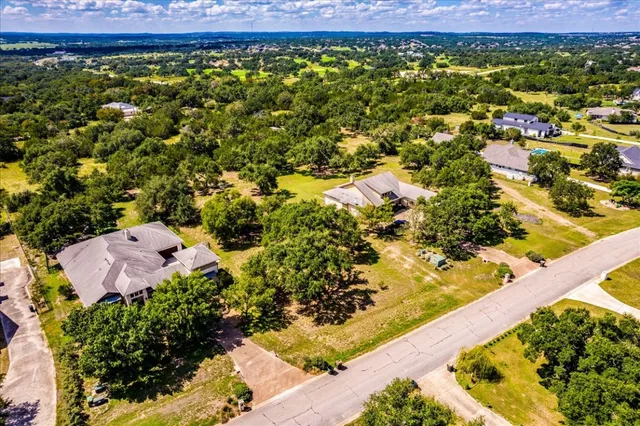 an aerial view of a house with a yard