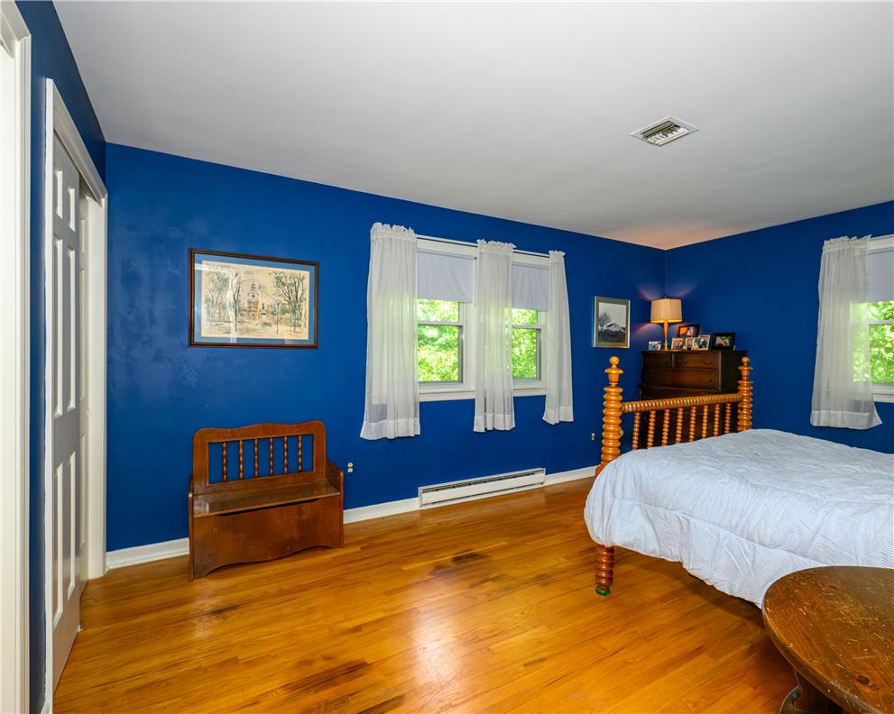 2516 Rachael Lane Orefield, PA 18069 - Photo 21 of 45 Sun-filled bedroom featuring classic hardwood flooring and multiple windows framing verdant exterior views.