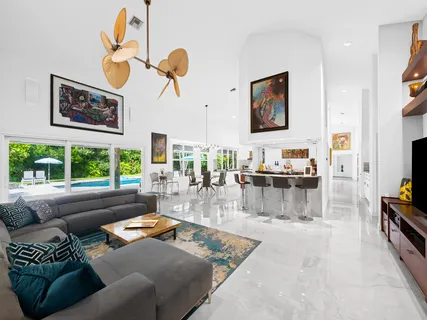 a bathroom with a granite countertop sink mirror and shower