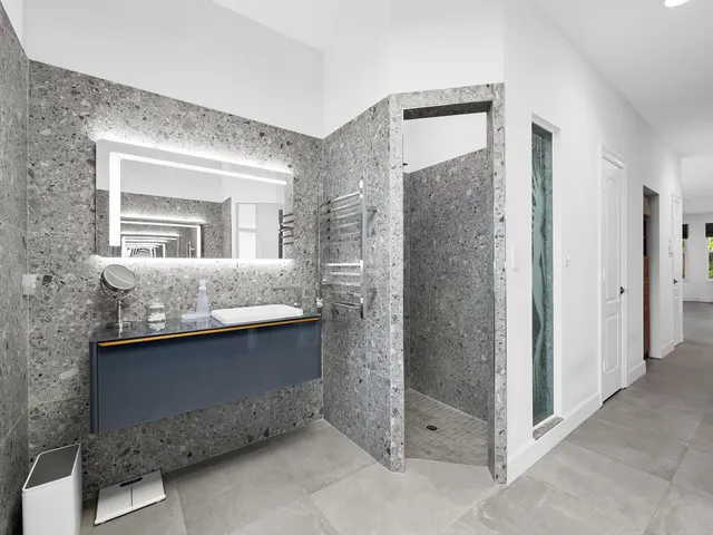 a bedroom with a bed and a chair with the wooden floor