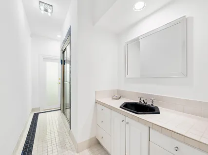 a view of a swimming pool with lawn chairs and plants