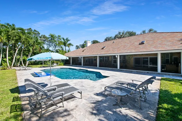 a view of swimming pool with outdoor seating