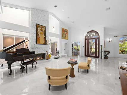 a view of a livingroom with furniture and a floor to ceiling window