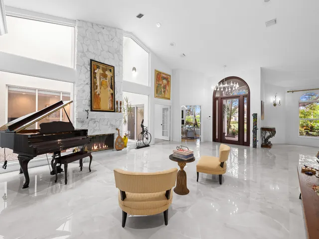 a view of a livingroom with furniture and a floor to ceiling window