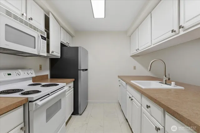 a spacious bedroom with a bed and a potted plant