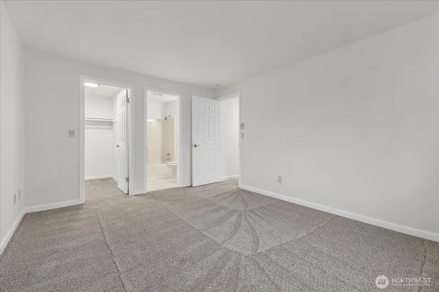 an empty room with a empty space and windows