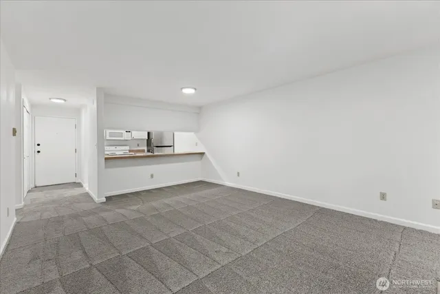 a kitchen with kitchen island a sink stove and white cabinets