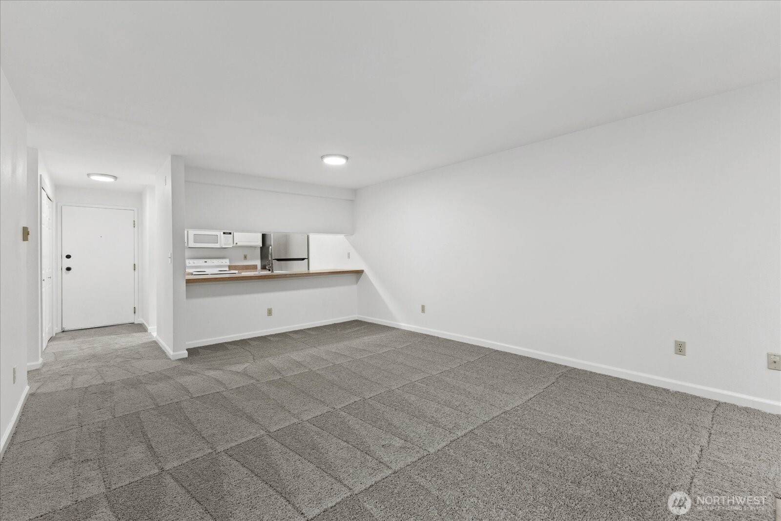 132 Northeast 95th Street, Unit B309 Seattle, WA 98115 - Photo 8 of 24 a view of a kitchen with refrigerator and a sink