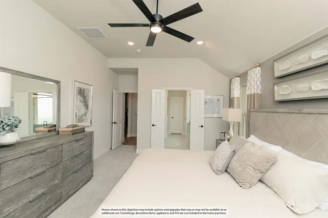 a bedroom with a large bed and chandelier