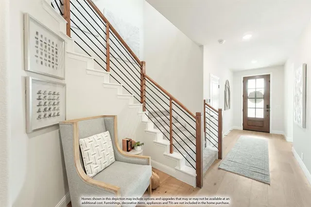 a view of entryway and hall with wooden floor