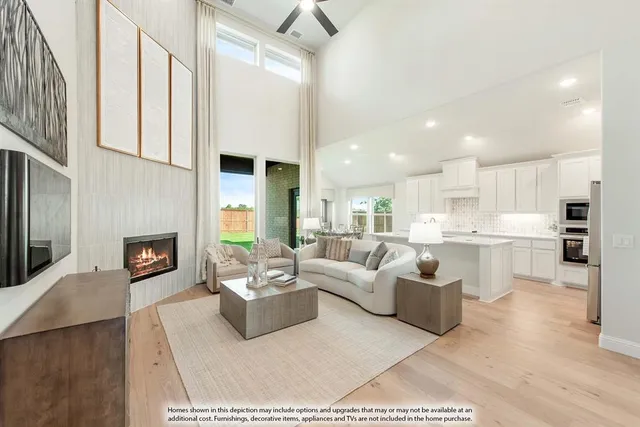 a living room with furniture a fireplace and a kitchen view