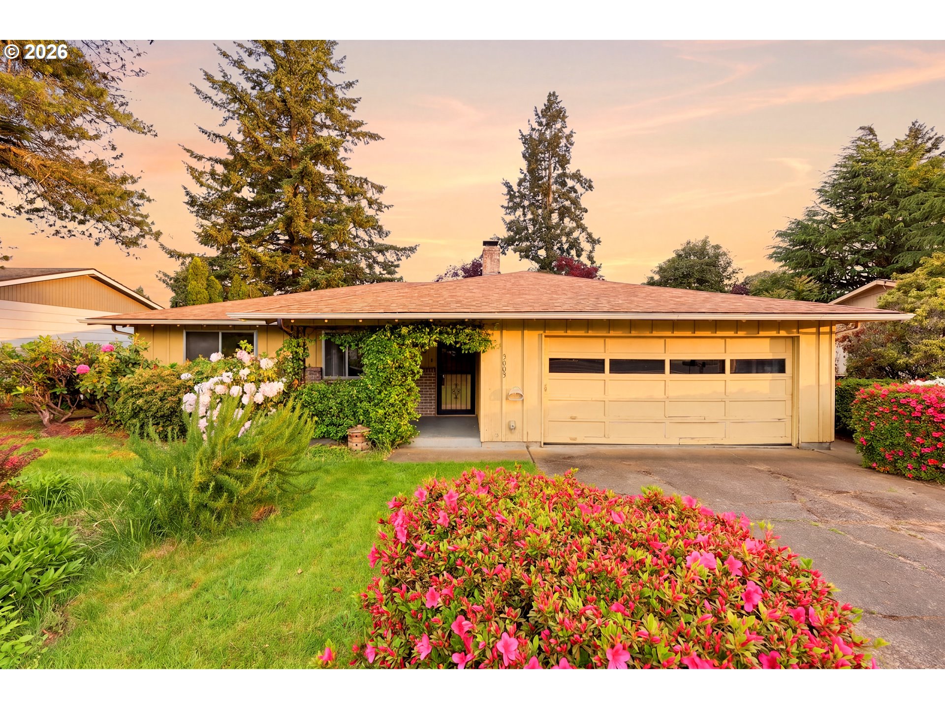 3003 Southeast 162nd Avenue Portland, OR 97236 - Photo 1 of 41 a front view of a house with garden