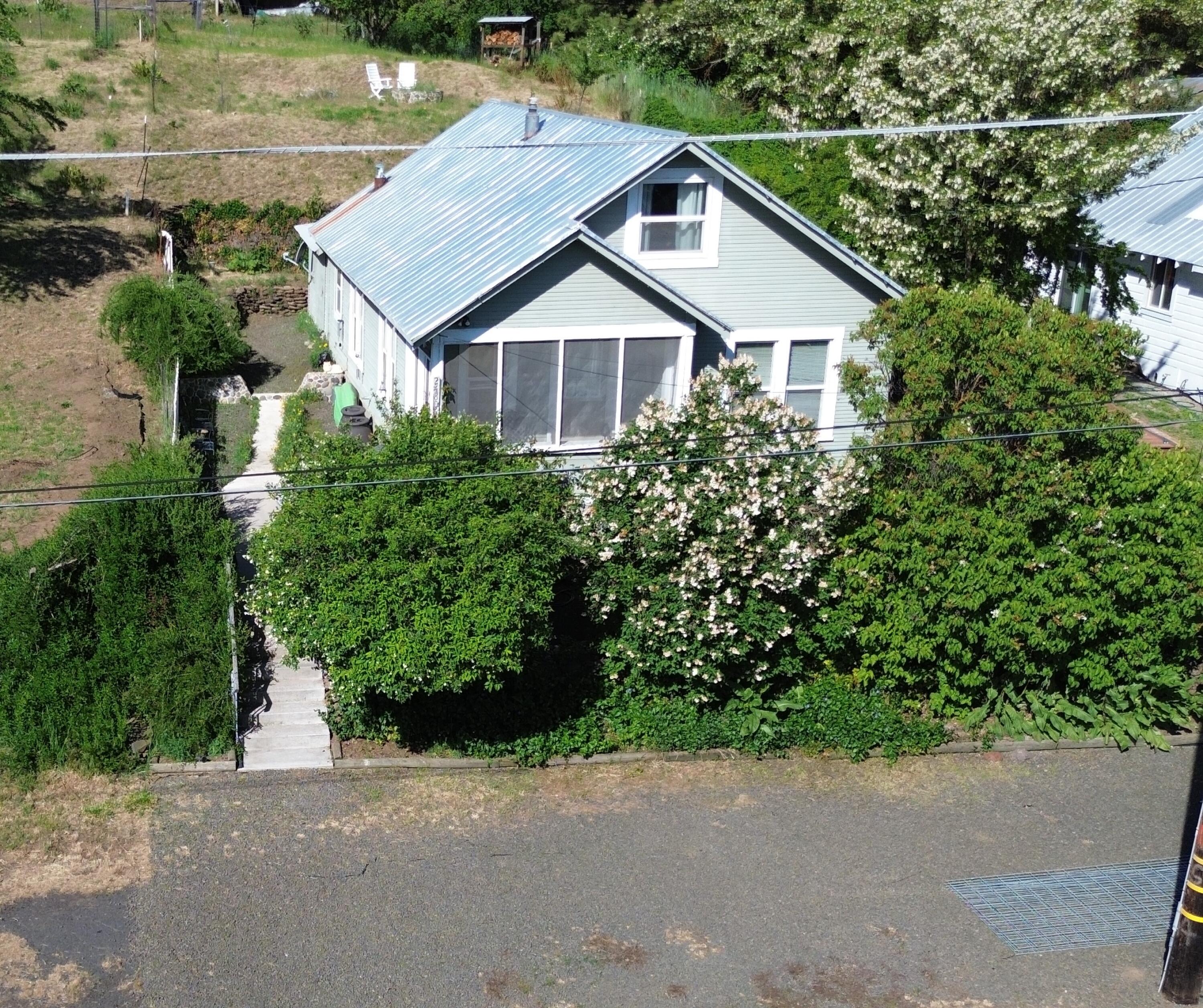 a aerial view of a house with a yard and potted plants