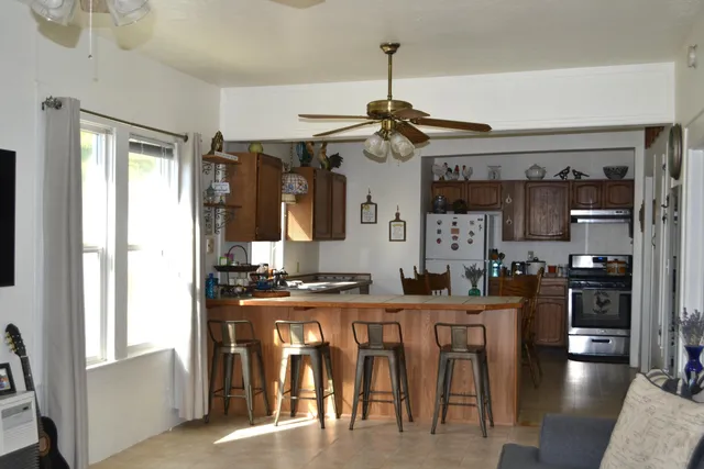 a kitchen with stainless steel appliances granite countertop a stove and a refrigerator