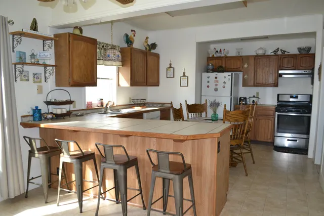 a dining table with chairs and cabinets