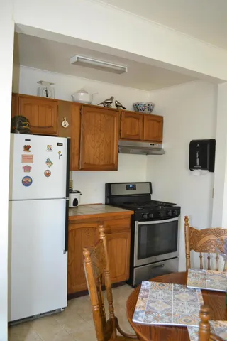 a kitchen with stainless steel appliances kitchen island a refrigerator sink and stove