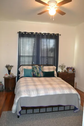 a bed sitting in a bedroom next to a larger window