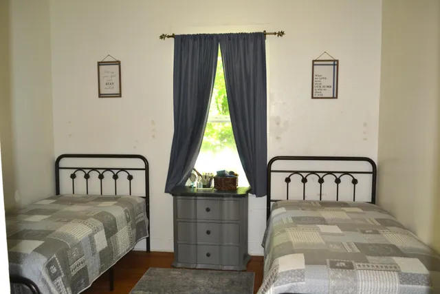 a bedroom with a bed and window