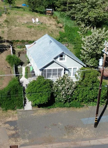 an aerial view of house with yard and outdoor seating