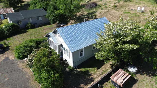a view of a house with a yard and wooden fence
