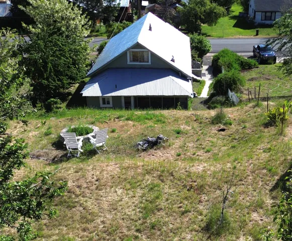 a view of a house with a yard and sitting area