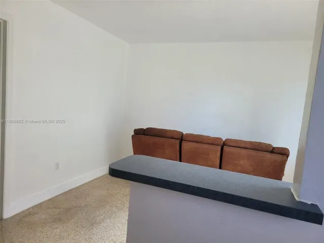 a living room with furniture and a dresser