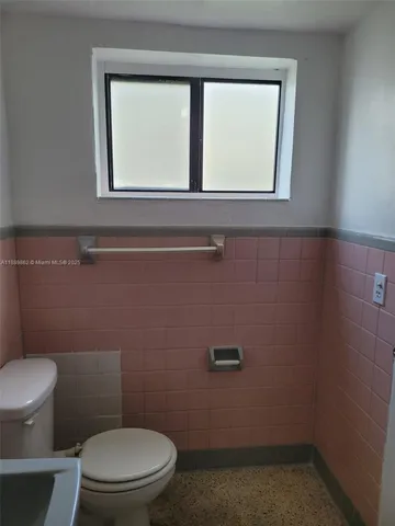 a bath tub sitting next to a white sink