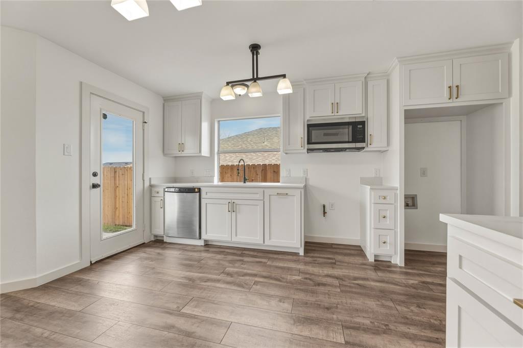 9808 Rockledge Road Fort Worth, TX 76108 - Photo 11 of 30 a kitchen with white cabinets and stainless steel appliances