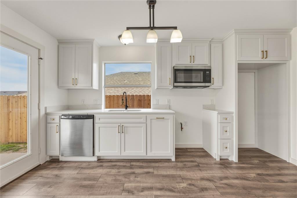 9808 Rockledge Road Fort Worth, TX 76108 - Photo 12 of 30 a kitchen with stainless steel appliances granite countertop a stove a microwave and a refrigerator