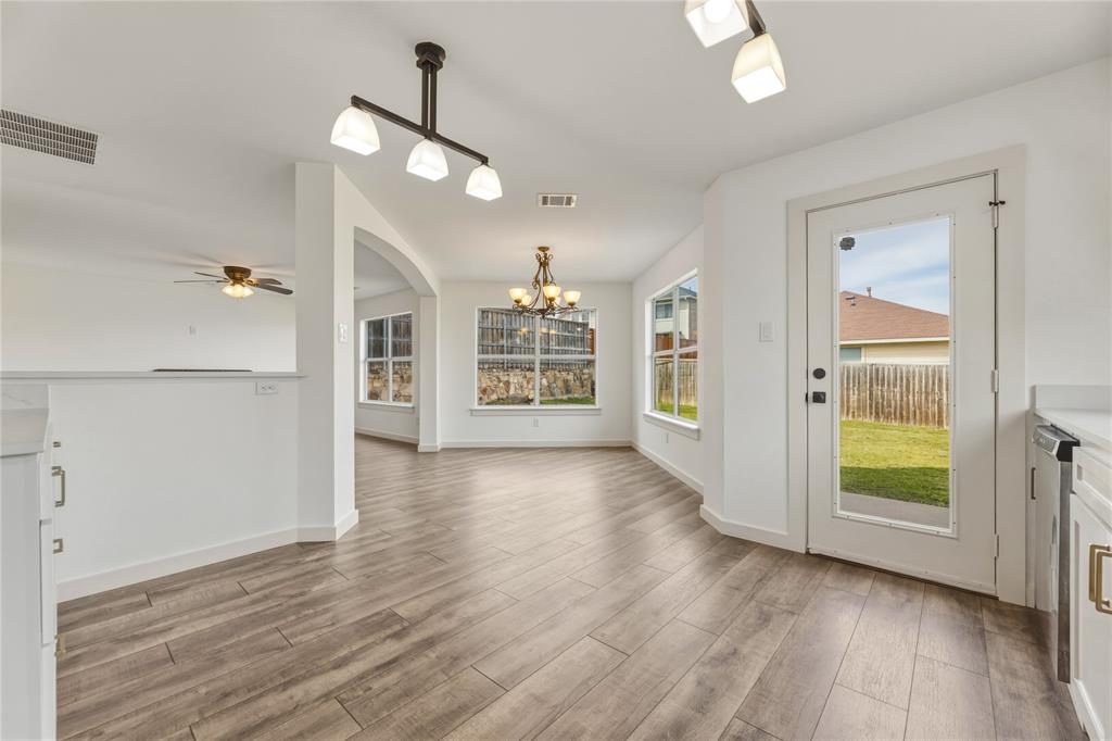 9808 Rockledge Road Fort Worth, TX 76108 - Photo 13 of 30 wooden floor in an empty room with a window