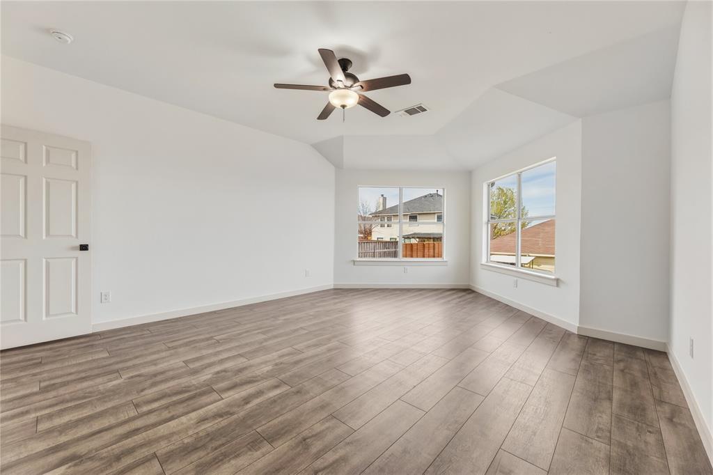 9808 Rockledge Road Fort Worth, TX 76108 - Photo 16 of 30 a view of empty room with wooden floor and fan