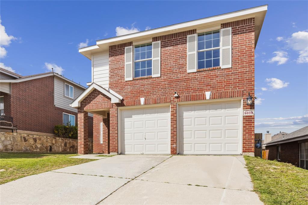 9808 Rockledge Road Fort Worth, TX 76108 - Photo 2 of 30 a front view of a house with a yard and garage