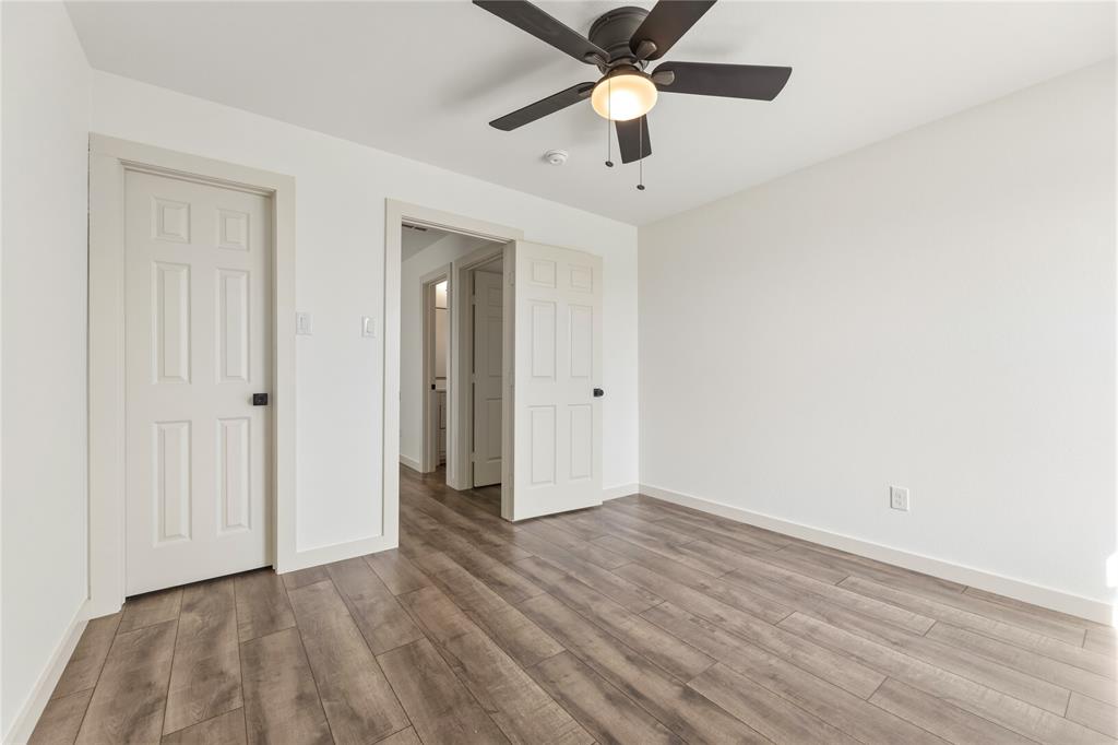 9808 Rockledge Road Fort Worth, TX 76108 - Photo 21 of 30 an empty room with wooden floor and a ceiling fan