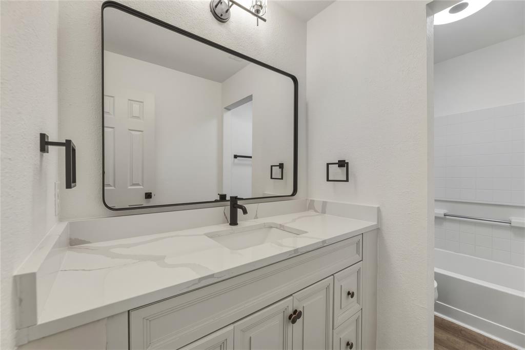9808 Rockledge Road Fort Worth, TX 76108 - Photo 22 of 30 a bathroom with a sink and a mirror