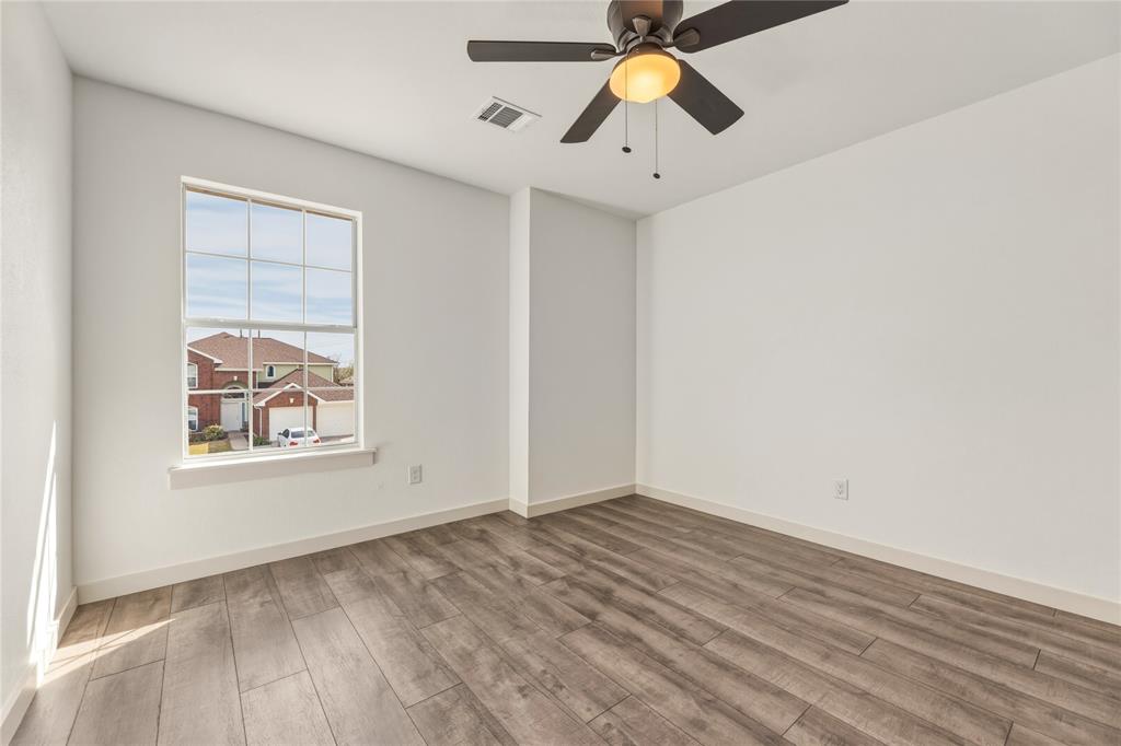 9808 Rockledge Road Fort Worth, TX 76108 - Photo 24 of 30 an empty room with a window and ceiling fan