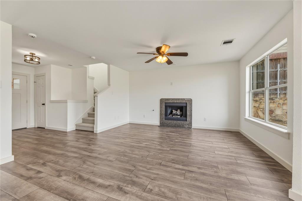 9808 Rockledge Road Fort Worth, TX 76108 - Photo 3 of 30 a view of an empty room with a window and a kitchen