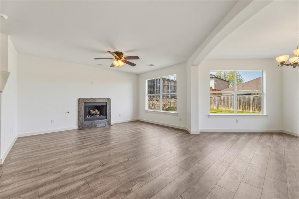 9808 Rockledge Road Fort Worth, TX 76108 - Photo 4 of 30 wooden floor in an empty room with a window