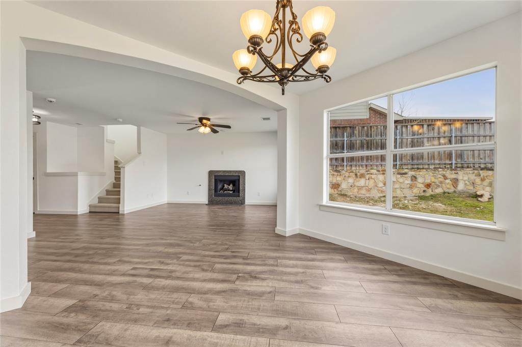 9808 Rockledge Road Fort Worth, TX 76108 - Photo 7 of 30 a view of a livingroom with a chandelier furniture and windows