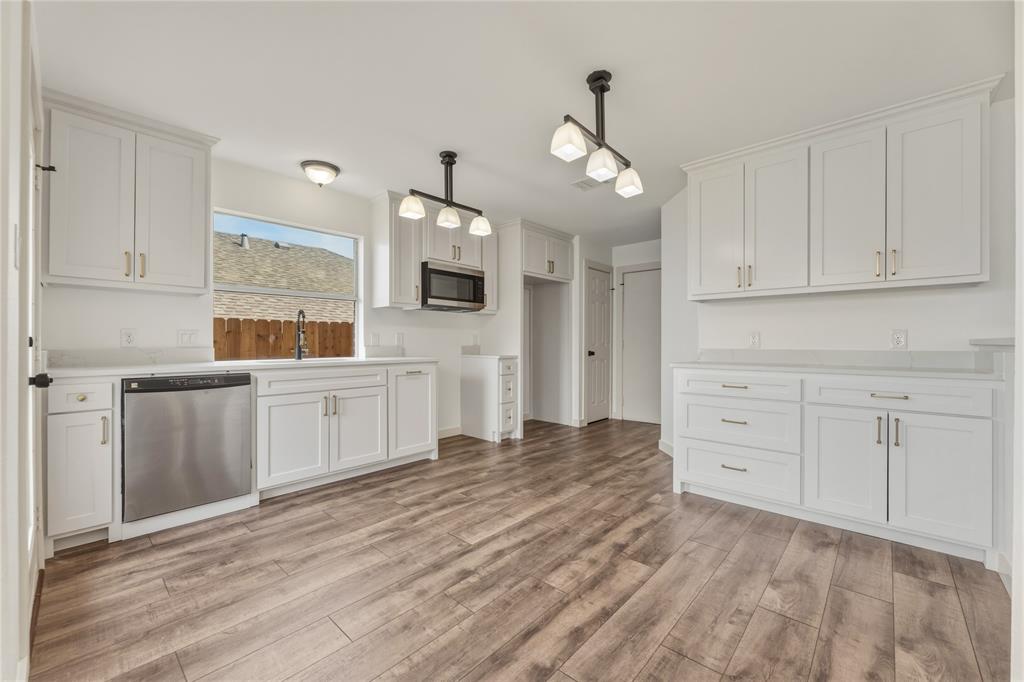 9808 Rockledge Road Fort Worth, TX 76108 - Photo 10 of 30 a kitchen with white cabinets and stainless steel appliances