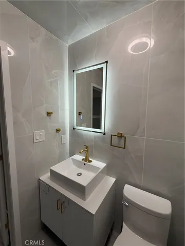 a bathroom with a sink toilet and mirror