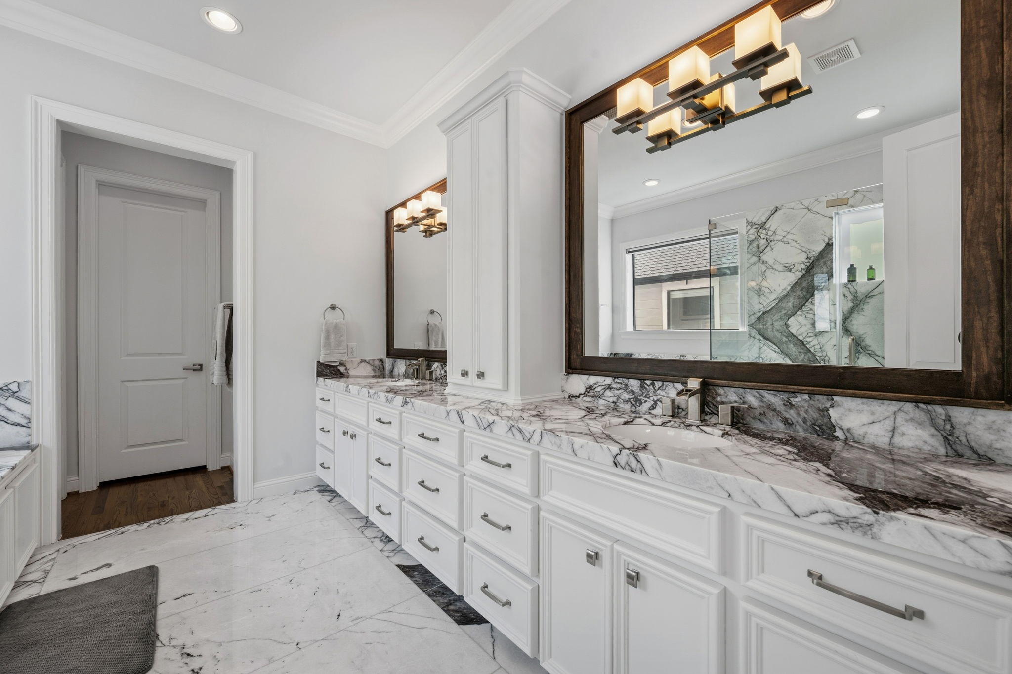 1235 West Bell Street, Unit A Houston, TX 77019 - Photo 15 of 38 Elegant primary bathroom featuring dual sinks and luxurious finishes.