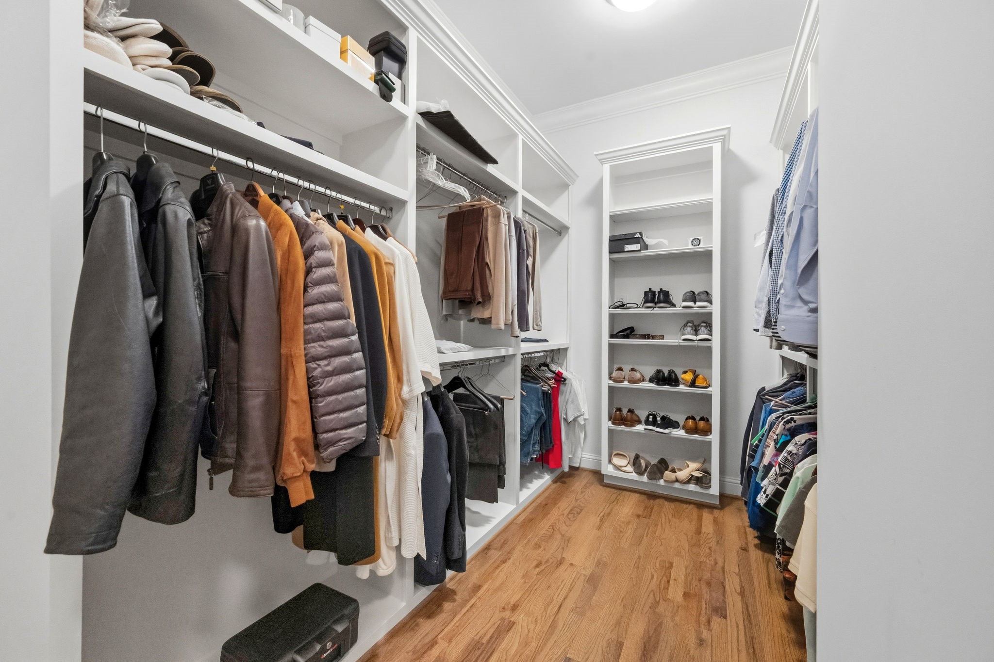 1235 West Bell Street, Unit A Houston, TX 77019 - Photo 18 of 38 a view of walk in closet with clothes and shoes
