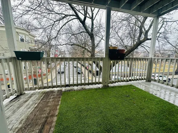 a view of a house with a yard and wooden fence