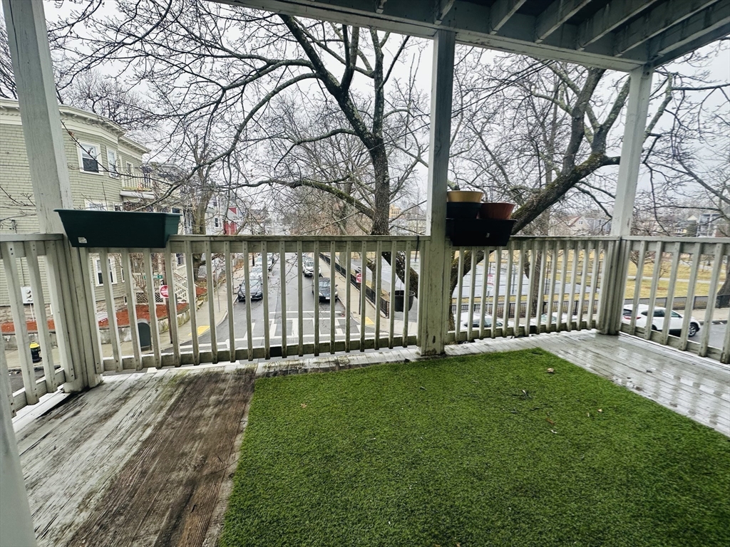 28 Melbourne Street, Unit 3 Boston, MA 02124 - Photo 23 of 27 a view of a house with a yard and wooden fence