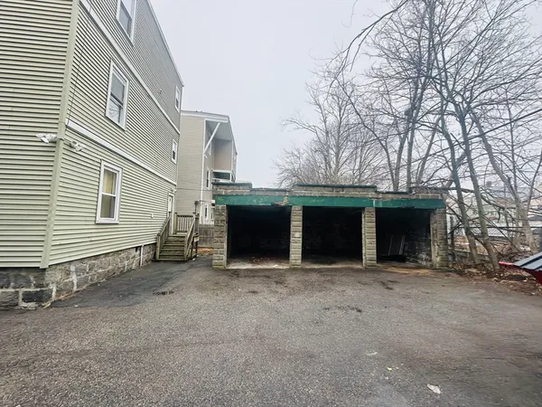 a view of a house with a yard and garage