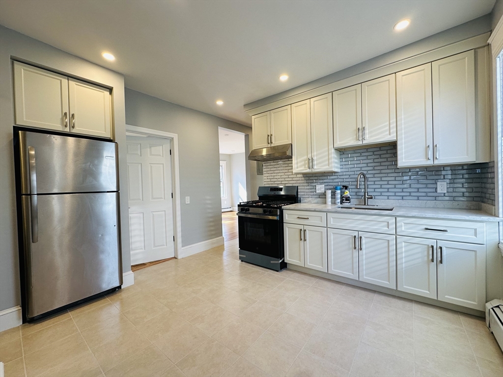 28 Melbourne Street, Unit 3 Boston, MA 02124 - Photo 5 of 27 a kitchen with stainless steel appliances granite countertop a refrigerator sink and cabinets
