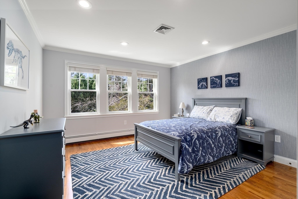 4 Pond Brook Circle Weston, MA 02493 - Photo 21 of 35 a bedroom with a bed and wooden floor
